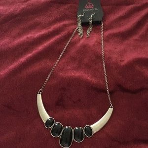 A silver and black design 14’ inches and earrings